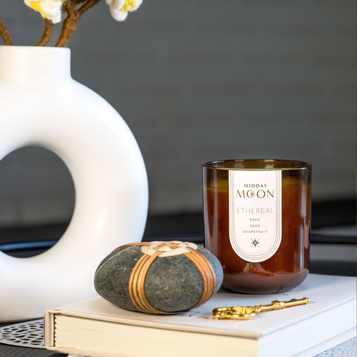 Midday moon candle in a dark brown glass jar. Scented soy candle smells like basil, sage, and grapefruit.