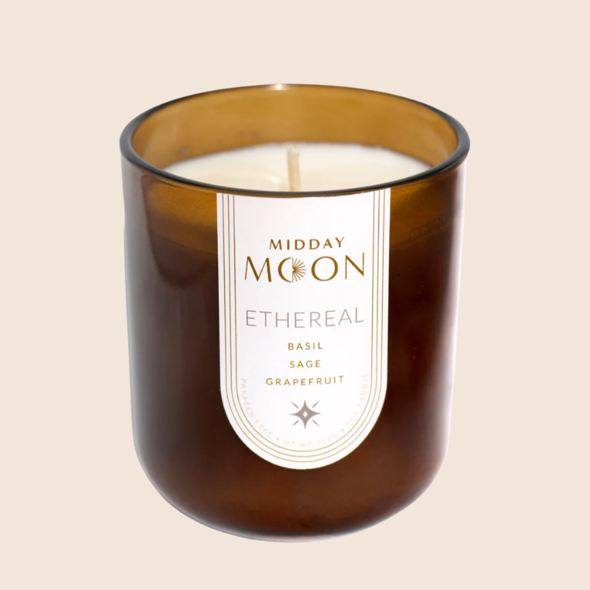ethereal scented soy candle on a plain background. Basil, sage, and grapefruit scented candle.