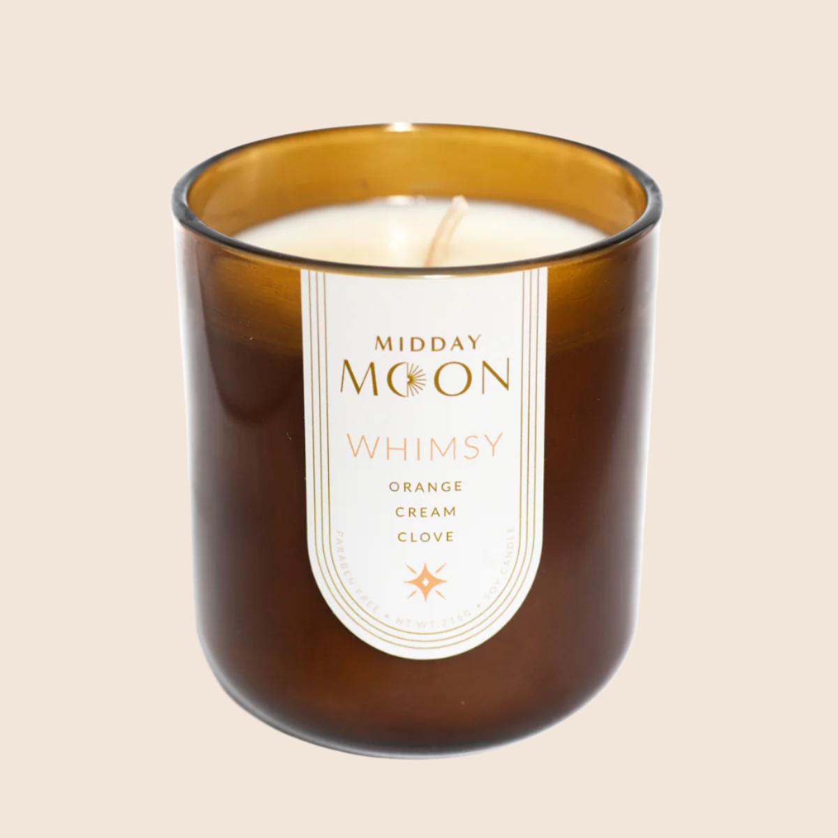whimsy handmade candle on a plain backdrop. Orange, cream, and clove scented candle.